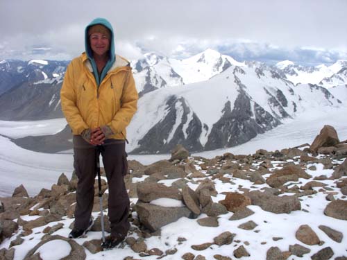 woman on top of snowy mountain